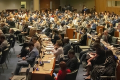 Image A large group of people sitting in a conference room