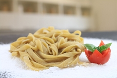 fiber-rich pasta next to a tomato.