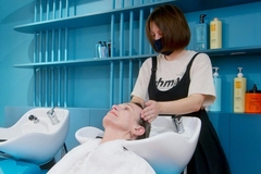 A hair dresser washing a clients hair.