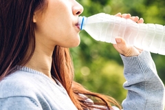 Image A person drinking from a bottle.
