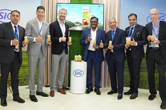 A group of men holding up their product.
