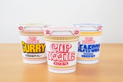 three cups of Nissin noodles.
