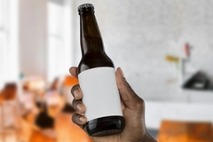 Image Holding beer bottle in hand.