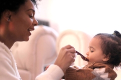 Image woman feeds baby with spoon