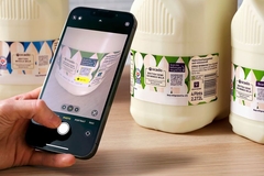 Image A phone scanning a QR code on a bottle.