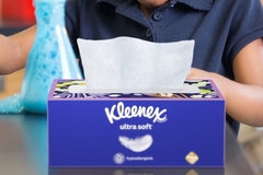 Image A box of Kleenex on a table.