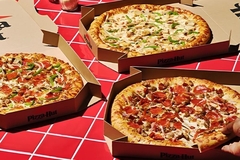 Image A group of pizzas in boxes