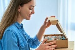 Woman unboxing parcel.