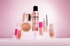 Image A collection of Revolution Beauty's makeup in front of a pink backrground.