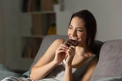 A woman eating chocolate.