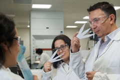 Image A group of scientists smelling scented paper.