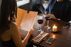 Image Person looking at a menu in a restaurant.