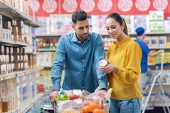 Image Man and woman checking the nutritin label in a supermarket.
