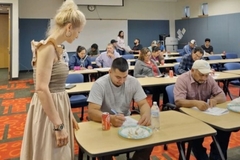 A woman standing in front of a group of students.