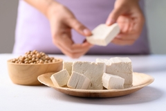 Woman eating tofu