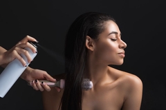 Image Girl-doing-styling-in-hair-salon with spray and brush