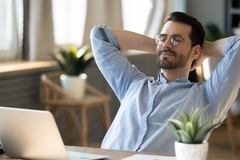 Image Man relaxing behind his computer because he used magnesium.