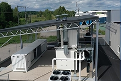 A large white structure with pipes on outdoor spaces
