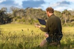 Image Person measuring soil health at a farm.