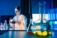 Image A scientist works in a darkened lab.