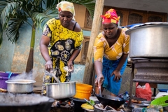 Image Two African women cooking outdoors