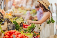 Image A young lady shopping at a farmer's market.