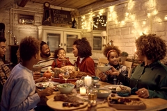 Image People eating a holiday dinner with family.