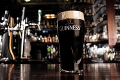 Image A pint of Guinness on a bar