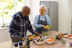 Image Man and woman cooking a healthy meal.