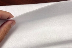 Image A person holding a white piece of material.
