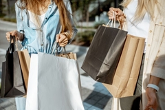 Women with paper-based shopping bags.