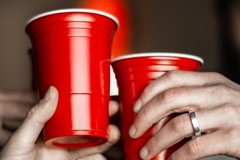 Holding up beverage cups.