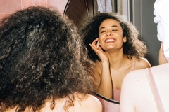 Woman looking at herself in mirror