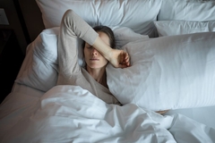 Image Tired woman laying in bed