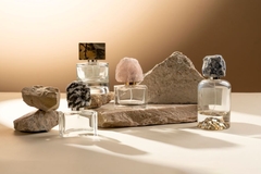 Image A collection of perfume bottles with marble tops.