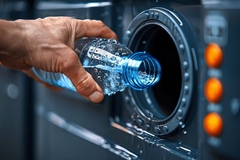 Image Placing empty plastic bottle in reverse vending machine.