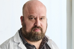 Image a mature bald man with beard.