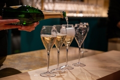 Image A bottle of champagne and glasses.