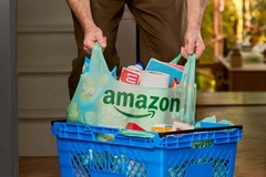 A person holding a plastic bag full of groceries.