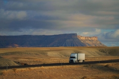 Image Supply chain cargo truck driving through green countryside