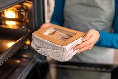 Image A person holding a box in towel in their hand
