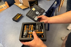 a box of black packets of honey.