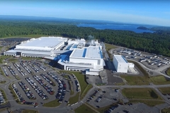 Image overhead of view of a factory next to water