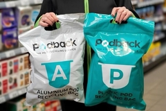 Image A person holding two plastic bags.