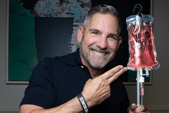 Image Grant Cardone pointing to IV bag