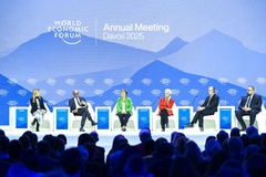 Image Speakers sitting on podium.