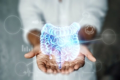 Image A woman holds out her hands and cradles a hologram of the intestines.