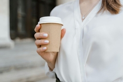 Image woman holding paper cup and lid