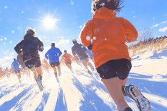 Image A group of people are running in the snow