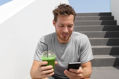 Image Man checking his meal plan on his phone.